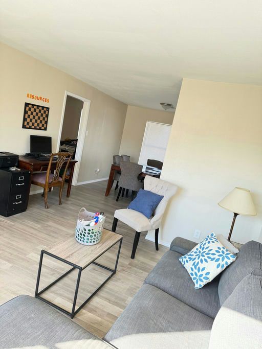 A tidy living area with a sofa, coffee table and a small desk
