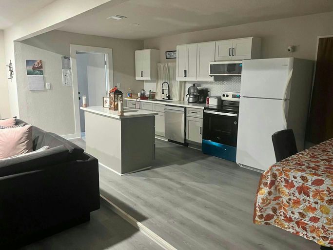 An open kitchen and living room in a furnished shared home