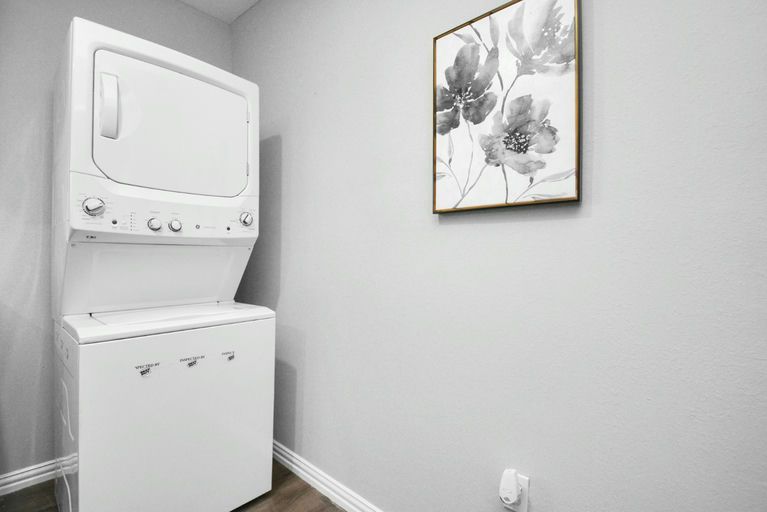 A laundry nook with a stacked washer and dryer
